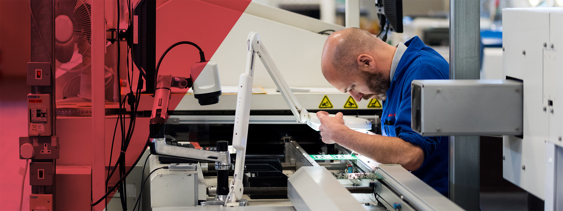 A Dynamic EMS engineer inspecting a PCB assembly under a magnifier